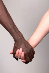 hands of an interracial couple